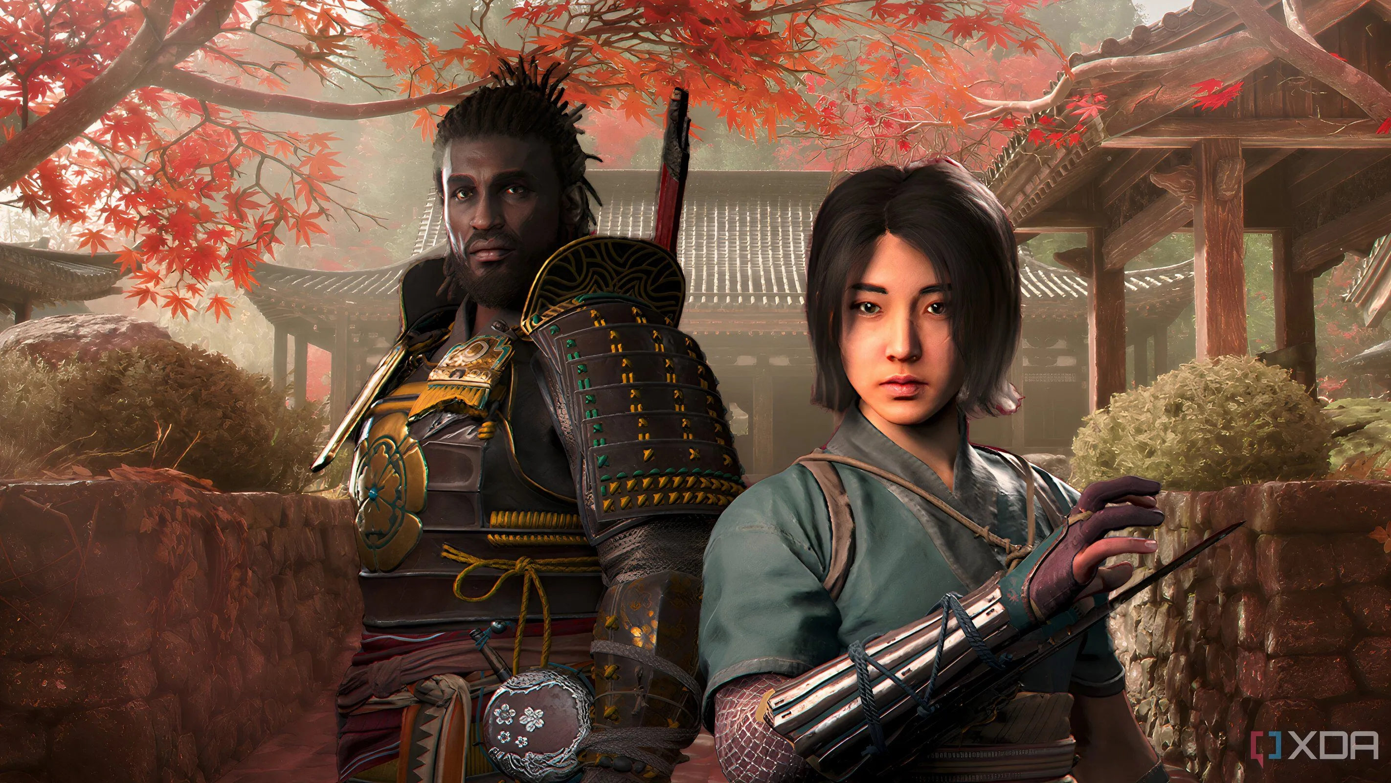 Hình ảnh Naoe và Yasuke đứng trước những hàng cây lá đỏ và kiến trúc Nhật Bản truyền thống