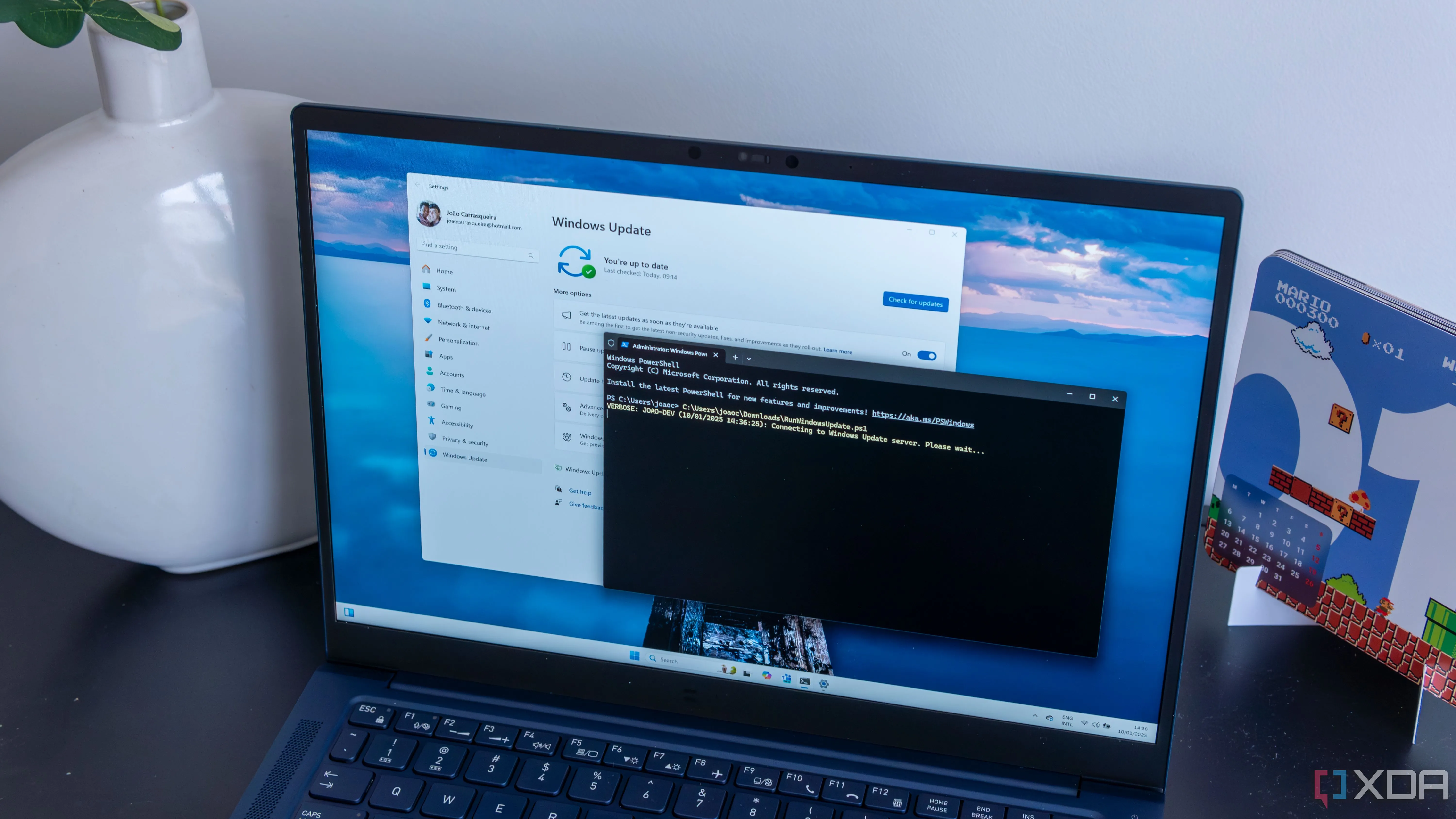 Laptop Windows 11 hiển thị giao diện PowerShell đang xử lý, minh họa công cụ hỗ trợ khắc phục lỗi cập nhật KB5055523.