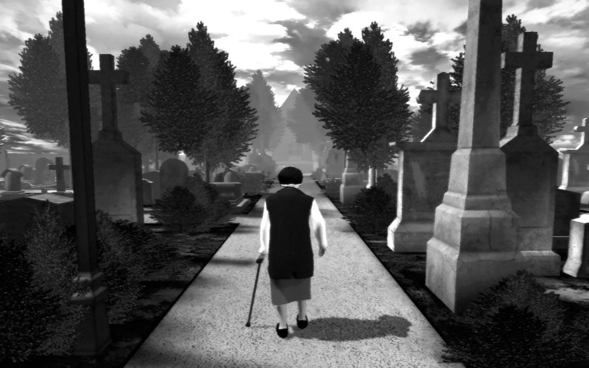 Screenshot của game The Graveyard hiển thị một người phụ nữ lớn tuổi đang đi bộ qua nghĩa địa trong khung cảnh tối tăm.